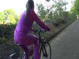 Watch Sandra riding her Bike in her sexy pink shiny nylon Rainsuit 9