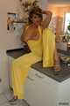 Busty Alexandra posing in a yellow jumbsuit in the kitchen 10